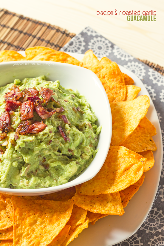 Bacon and Roasted Garlic Guacamole | Annie's Noms - This is no normal guacamole! This mind-blowing homemade guacamole has roasted garlic, bacon and fried onions in! Served with tortilla chips, this will be one appetizer you won't want to share!