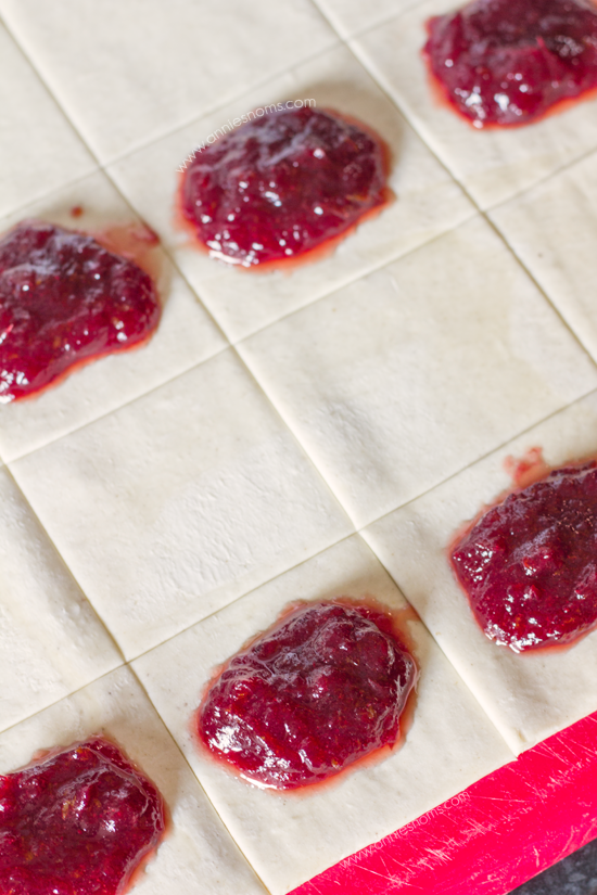 Cranberry and Orange Hand Pies - Festive hand pies filled with cranberry and orange and drizzled with white chocolate.