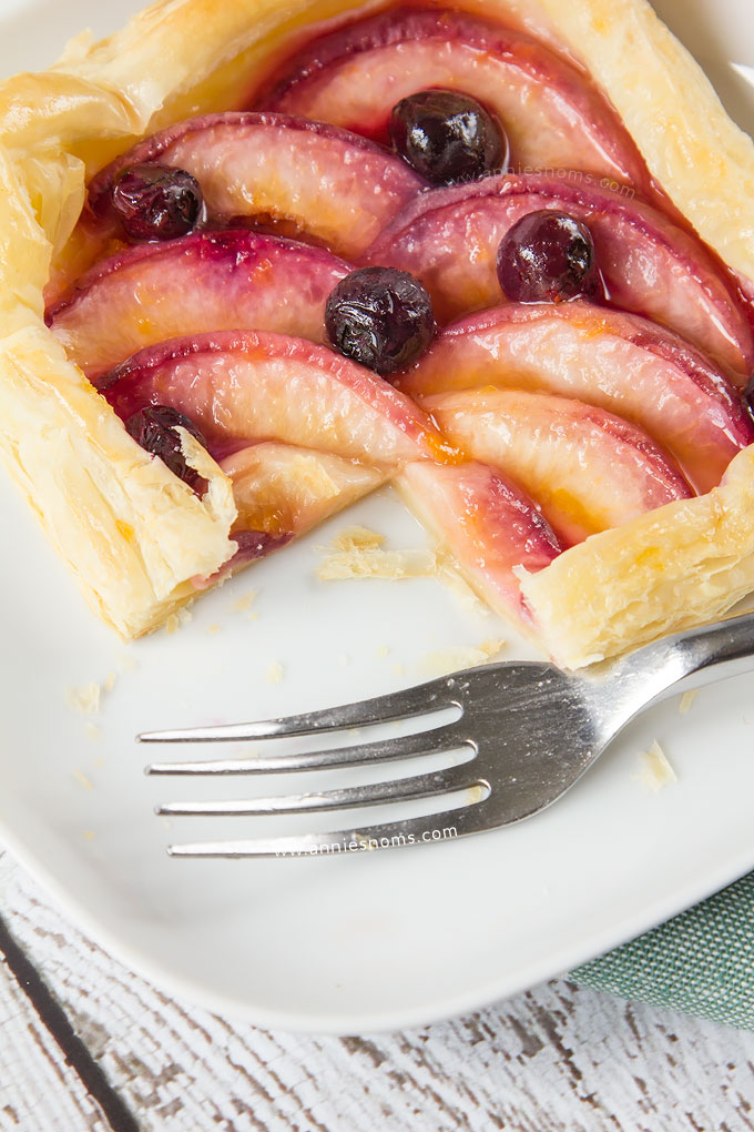 My simple Peach and Blueberry Mini Tarts are so easy to make, yet bursting at the seams with sweet fruit. Shop bought puff pastry is layered with sliced peaches and fresh blueberries before being baked until golden. The perfect Summer dessert!