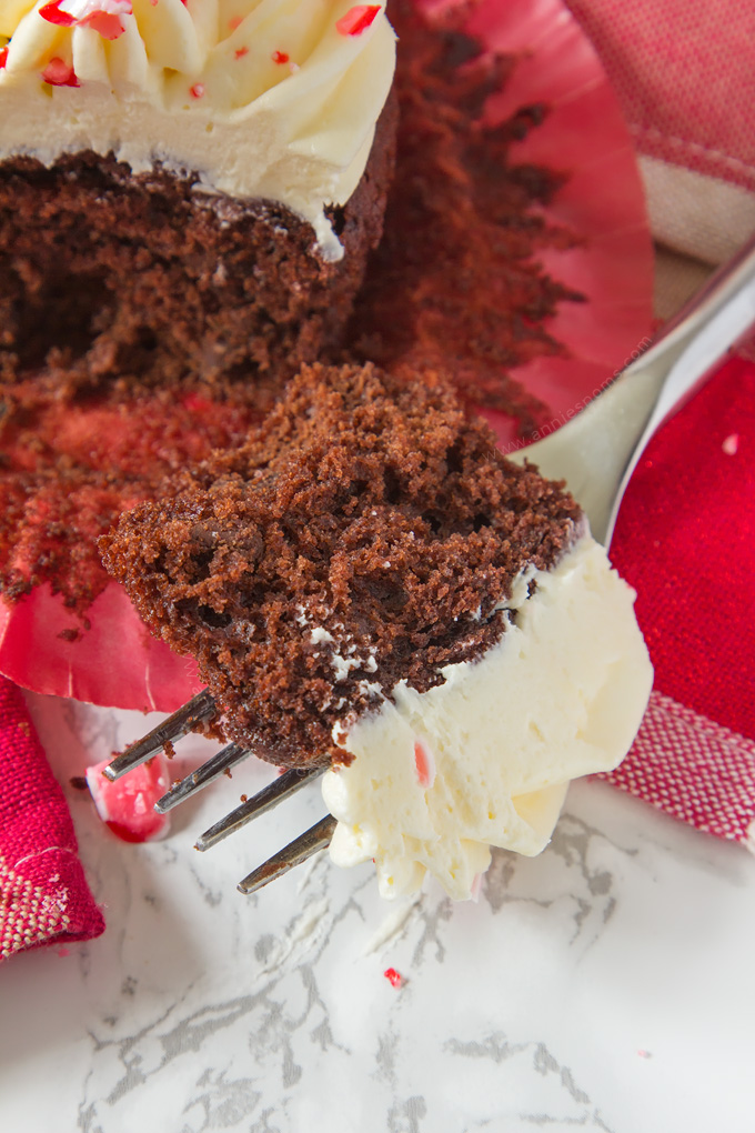 A soft, rich chocolate and peppermint cupcake is topped with smooth, peppermint frosting and finished off with crushed candy canes, creating a fun, festive cupcake!