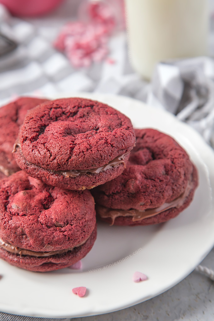 Soft, chewy Chocolate Chip filled Red Velvet Cookies sandwiched together with creamy, smooth chocolate spread to make a cute and delicious Valentine's treat!