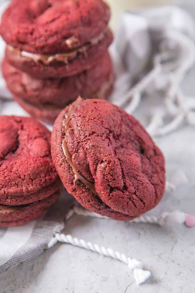 Soft, chewy Chocolate Chip filled Red Velvet Cookies sandwiched together with creamy, smooth chocolate spread to make a cute and delicious Valentine's treat!