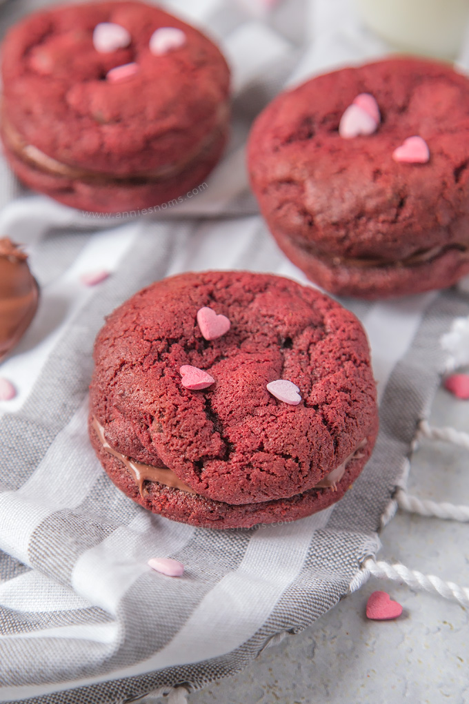 Soft, chewy Chocolate Chip filled Red Velvet Cookies sandwiched together with creamy, smooth chocolate spread to make a cute and delicious Valentine's treat!