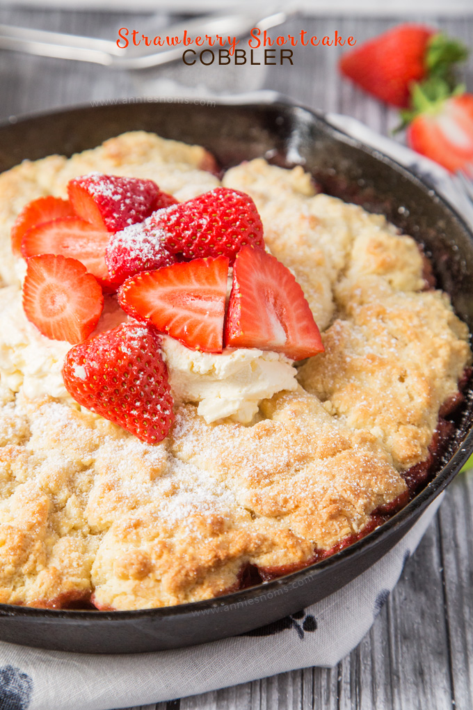 This Strawberry Shortcake Cobbler is filled with juicy strawberries, topped with a light as air shortcake and whipped cream; the perfect Summer dessert for sharing!