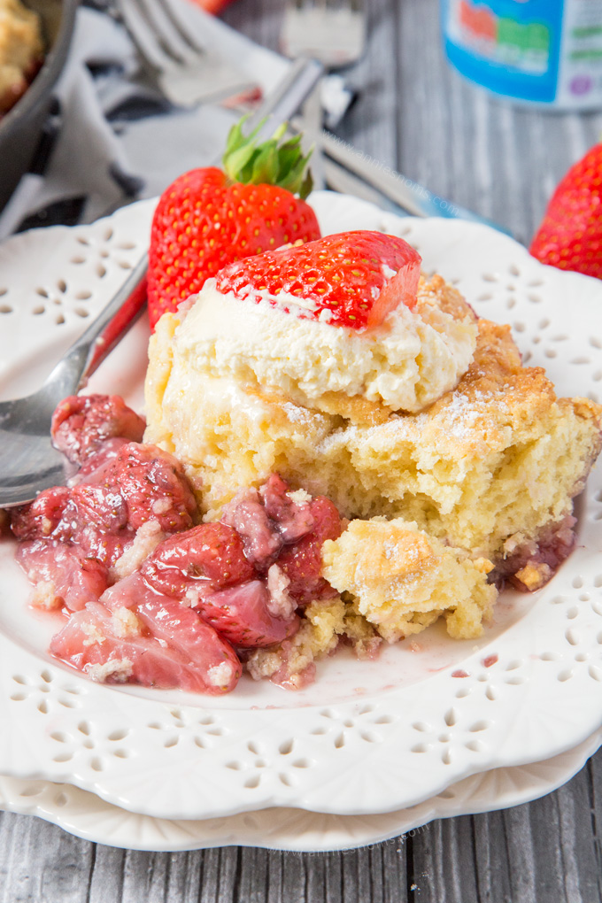 This Strawberry Shortcake Cobbler is filled with juicy strawberries, topped with a light as air shortcake and whipped cream; the perfect Summer dessert for sharing!