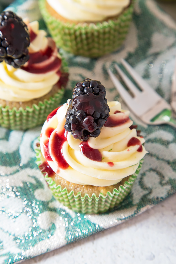 Soft, blackberry filled cupcakes with lime butter cream frosting and blackberry coulis. An explosion of flavour in every bite!