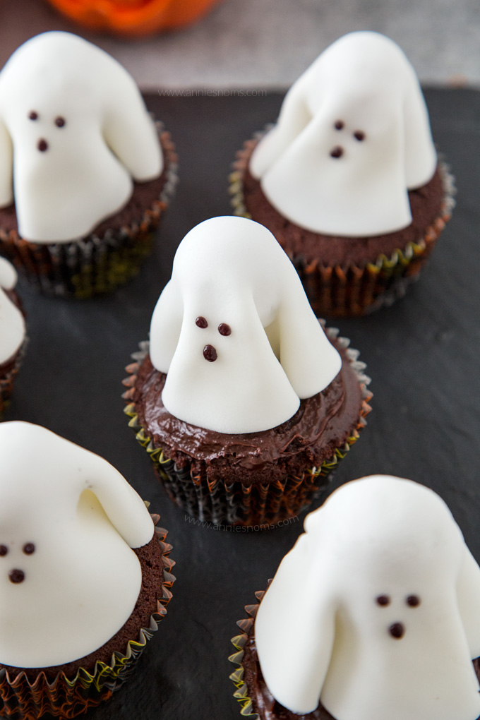 A chocolate frosted cupcake with a fondant ghost atop it; these Ghost Cupcakes are treats that adults and kids alike will love!