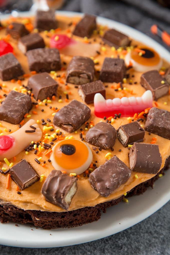 A thick and chewy brownie topped with creamy buttercream and leftover Halloween sweets. Fun to make and super delicious!