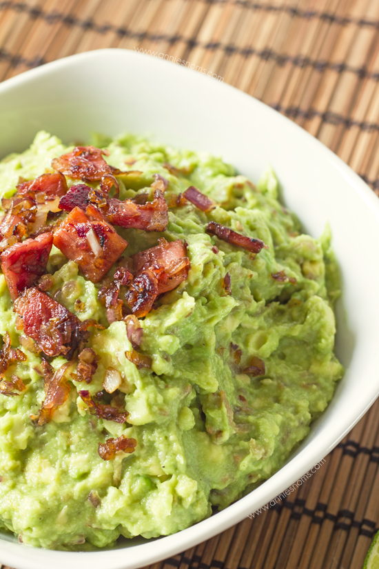Bacon and Roasted Garlic Guacamole | Annie's Noms - This is no normal guacamole! This mind-blowing homemade guacamole has roasted garlic, bacon and fried onions in! Served with tortilla chips, this will be one appetizer you won't want to share!