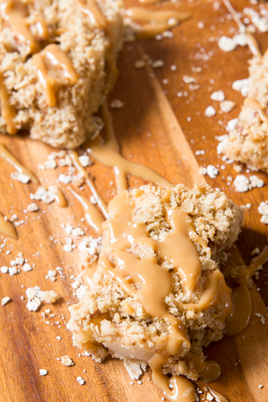 Caramel Apple Oatmeal Bars | Annie's Noms - These Caramel Apple bars are so easy to make, yet beautifully satisfying! A crumbly oat mixture is layered with spiced apples before being baked and drizzled with caramel sauce. All of our favourite Fall flavours in one bar.