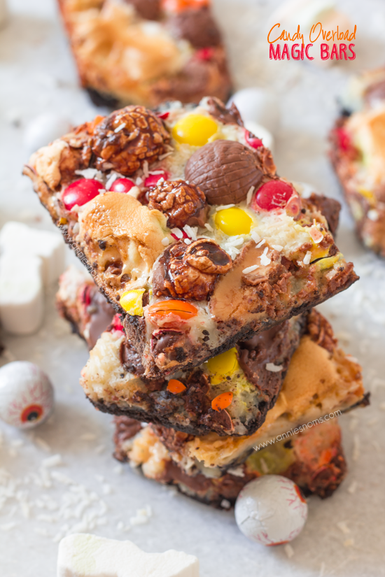 Candy Overload Magic Bars | Annie's Noms - An Oreo base is topped with condensed milk, shredded coconut and a myriad of candy creating a soft gooey, chocolatey magic bar!