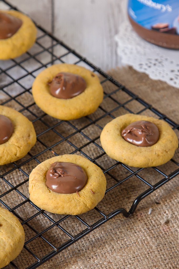 These Pumpkin Nutella Thumbprint Cookies are little bites of heaven. Spiced cookies, baked until slightly crisp, with gooey, rich Nutella spooned into the middle make these cookies simply irresistible!
