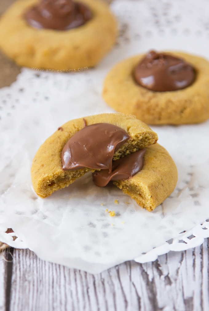 These Pumpkin Nutella Thumbprint Cookies are little bites of heaven. Spiced cookies, baked until slightly crisp, with gooey, rich Nutella spooned into the middle make these cookies simply irresistible!