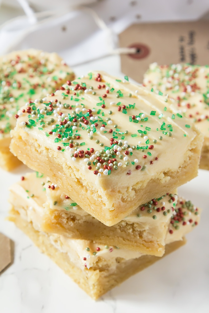 Thick and chewy Sugar cookie dough baked into bars and frosted with velvety smooth buttercream and festive sprinkles!