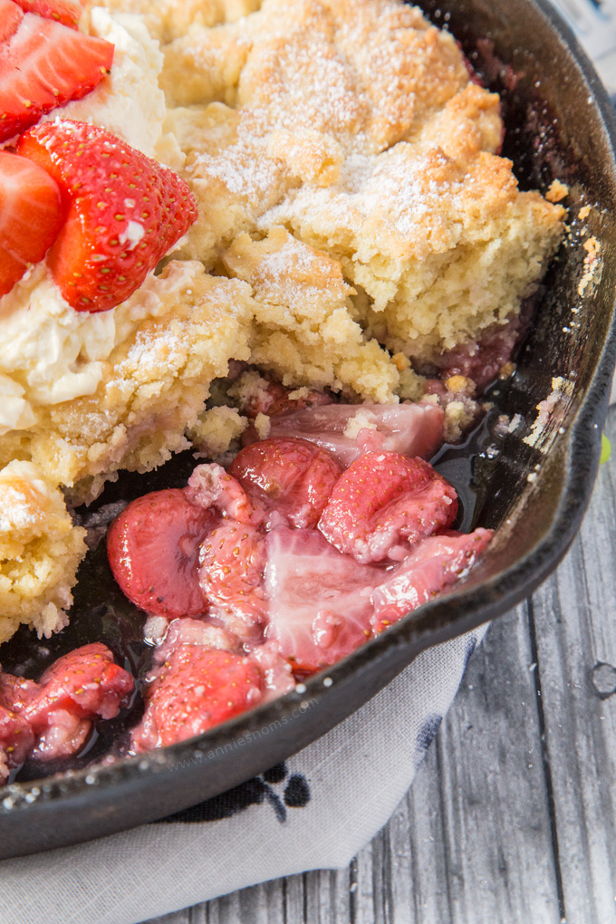 This Strawberry Shortcake Cobbler is filled with juicy strawberries, topped with a light as air shortcake and whipped cream; the perfect Summer dessert for sharing!