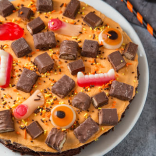 A thick and chewy brownie topped with creamy buttercream and leftover Halloween sweets. Fun to make and super delicious!