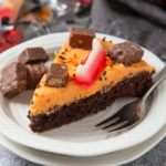 A thick and chewy brownie topped with creamy buttercream and leftover Halloween sweets. Fun to make and super delicious!