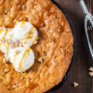 Soft and chewy cookie dough filled with butterscotch and white chocolate chips. Baked until golden and served with ice cream, this skillet cookie is almost too good to share!