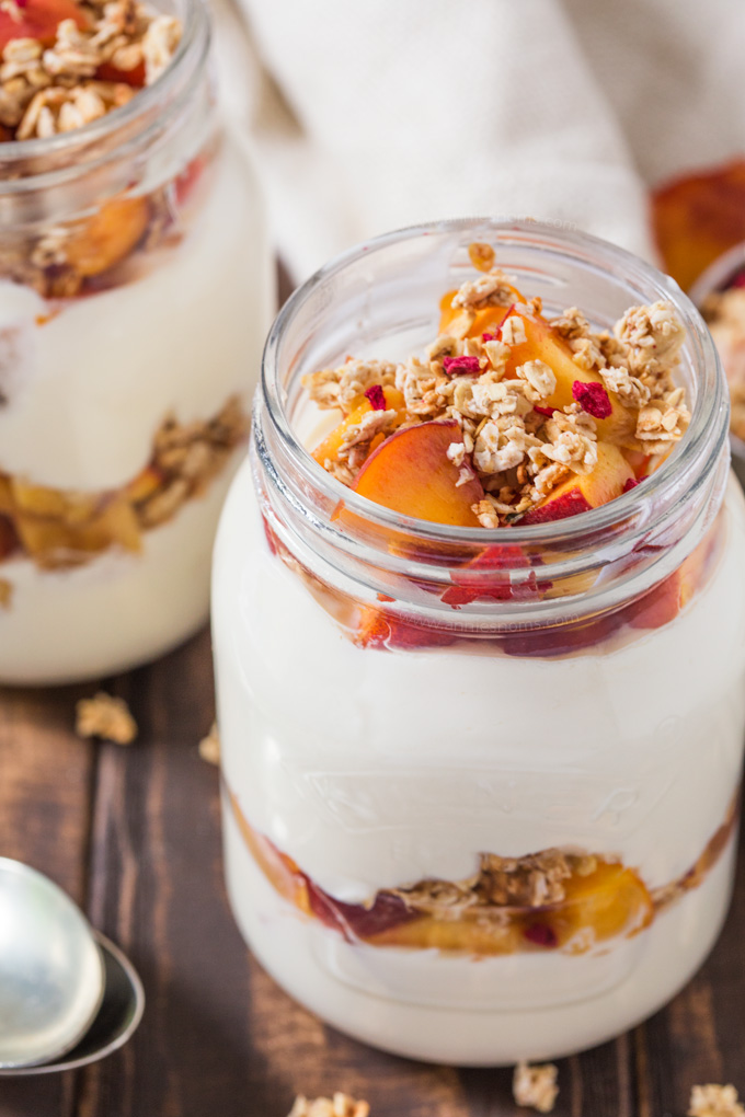 These Peach Parfaits are made with creamy Greek yoghurt, sweet peaches and crunchy granola; light and tasty, you decide whether these are breakfast or dessert!