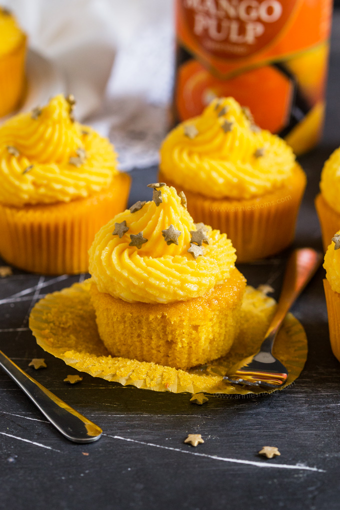 These soft Mango Cupcakes are filled with crushed pineapple and topped with a light and fluffy mango frosting. A delicious tropical cupcake perfect for the warmer weather!