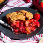 Sweet strawberries and tart rhubarb are married together with a crisp, yet fluffy top to make this sublime cobbler which you'll make again and again!