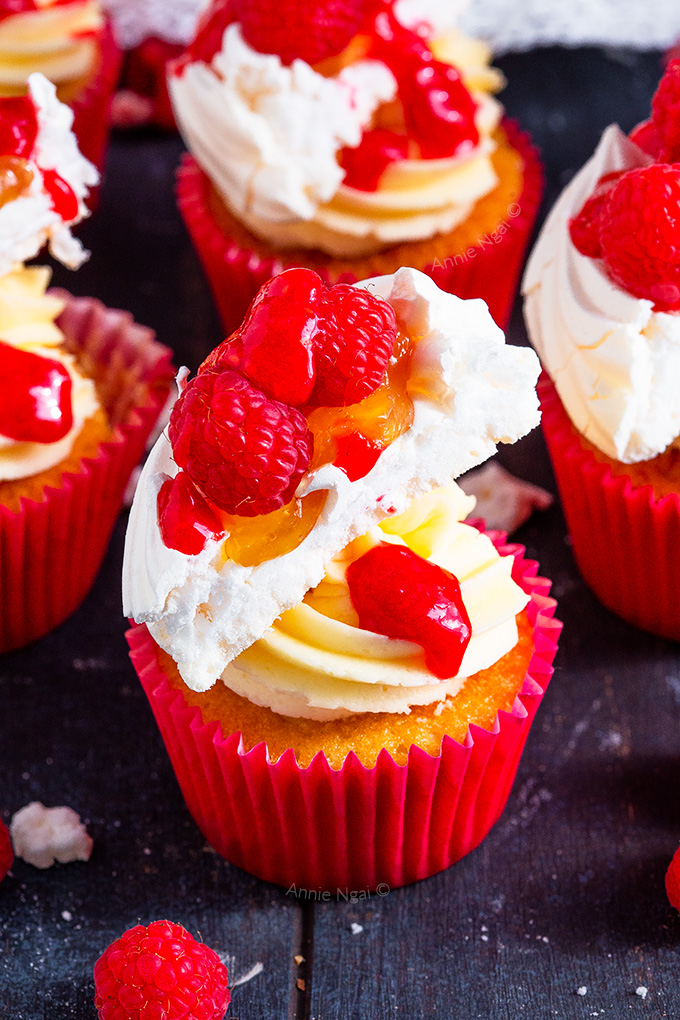 These Lemon and Raspberry Pavlova Cupcakes marry together soft, fluffy lemon cupcakes with lemon curd, frosting, meringue, raspberries AND raspberry sauce to create one seriously divine cupcake!