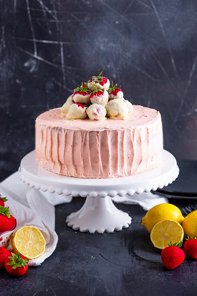 This Strawberry Lemon Layer Cake marries together a lemon cake, lemon curd filling, fresh strawberries and jam buttercream to make one seriously delicious layer cake!