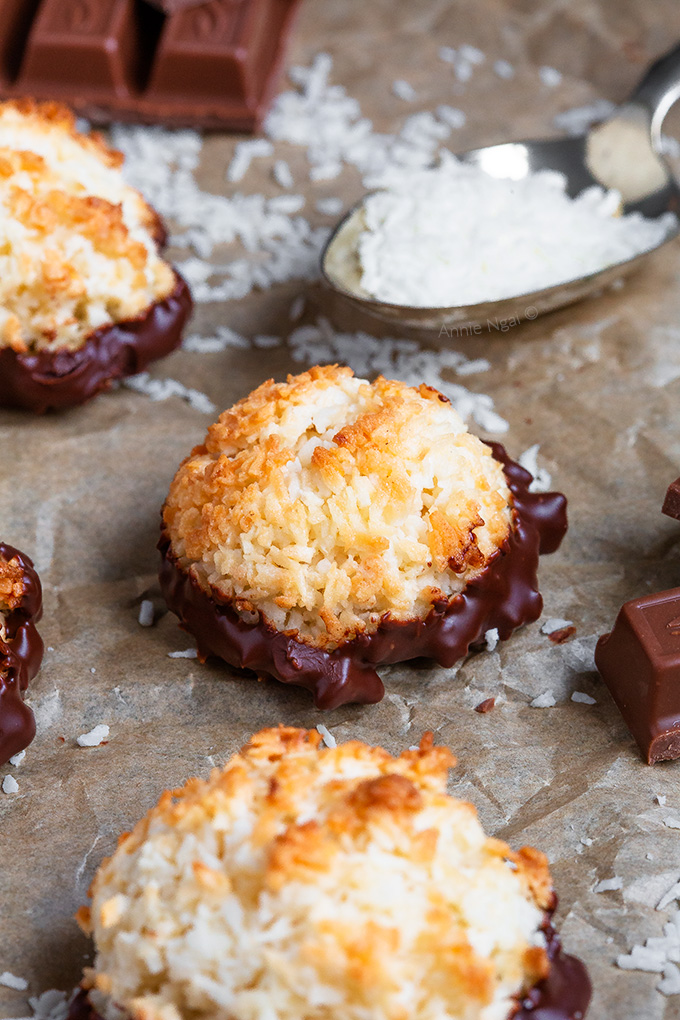These Coconut Macaroons are ridiculously easy to make and only need a few ingredients! Baked until golden and dipped in chocolate, they're the perfect bitesize treat!